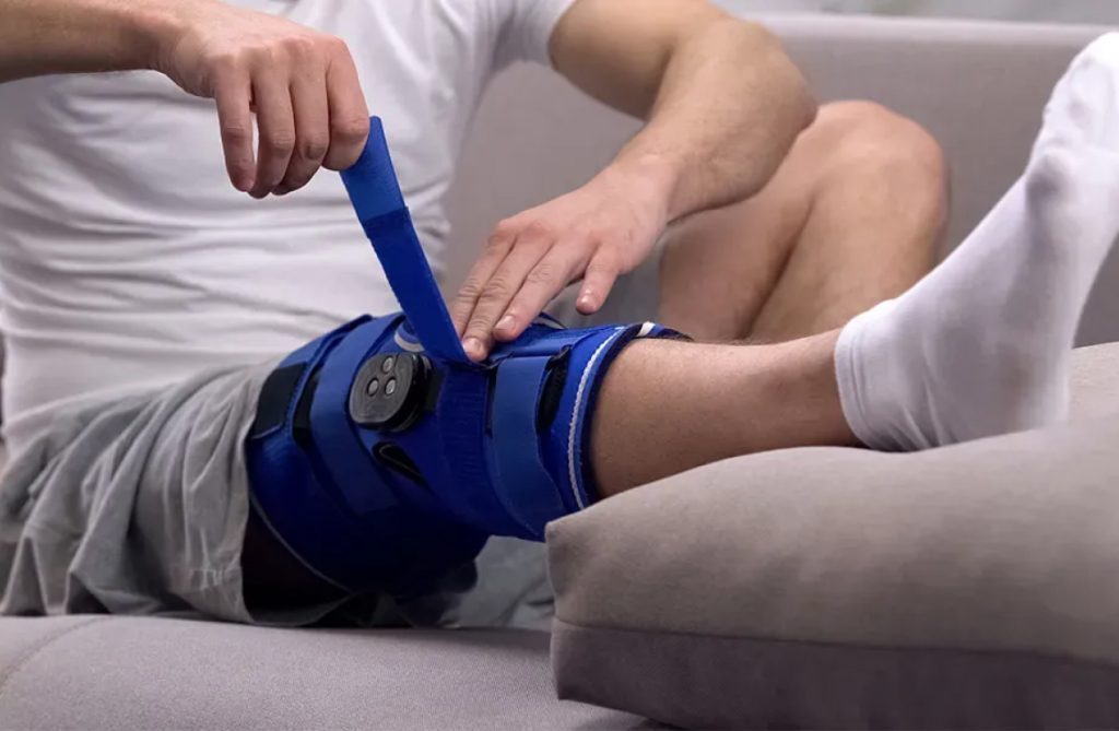 Man adjusting his knee brace